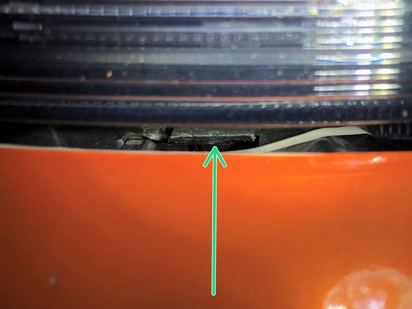 Using a plastic interior trim removal tool, lift up the two tabs to release them