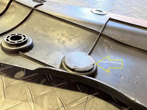 If you struggle to remove the rubber stop you can use your pry tool to pry up from the underside in the area of the yellow arrow