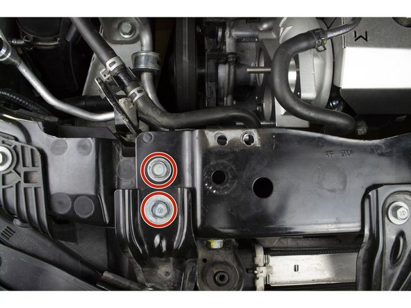 With a 12mm socket wrench remove the two (2) 12mm bolts