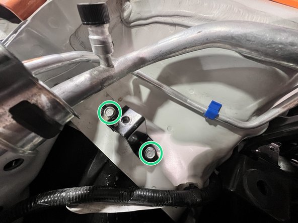 Use a 3/8&quot; ratchet and 10mm socket to remove (2) 10mm bolts securing the upper chassis tank bracket