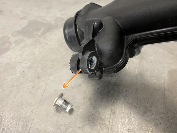 Squeeze the rubber isolator and pull out sideways