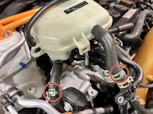Use needle nose pliers to squeeze and slide back clamps on both upper and lower coolant hoses