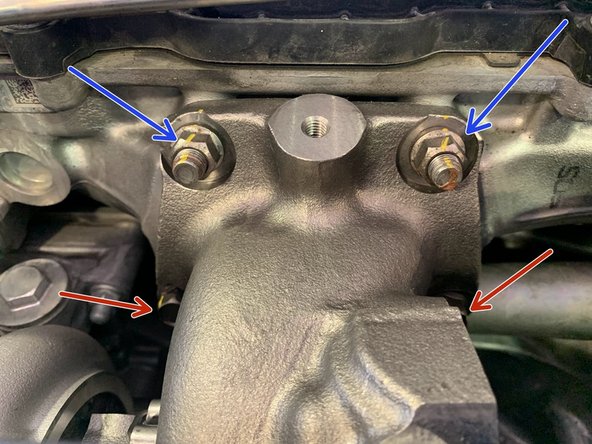 Align the holes of the turbine housing to the upper studs of the cylinder head