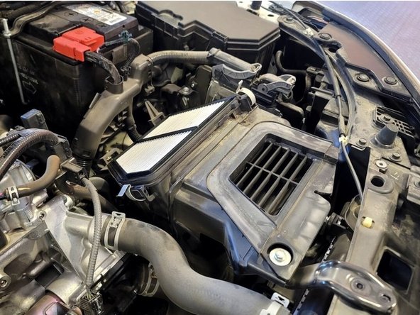 The OE intake should be free to remove now and only attached to the lower sound dampener