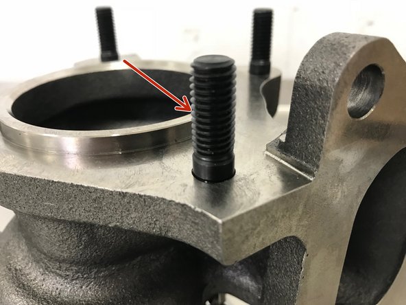 (Shown on Bench for Clarity) By hand, install the four (4) M10 studs into the turbo with the long section out