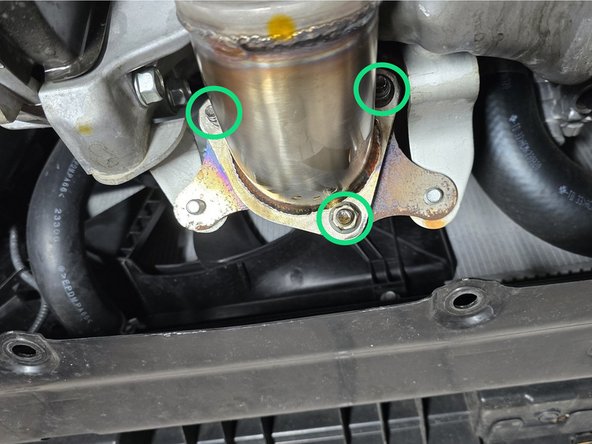 Push the exhaust hanger over the stud as shown