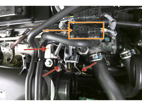 Re-route the secondary O2 sensor wire harness back into the appropriate tabs,  securing the black round spot in the tabs