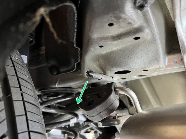 Using a spray cleaner, lubricate the rear hangers and rubber supports