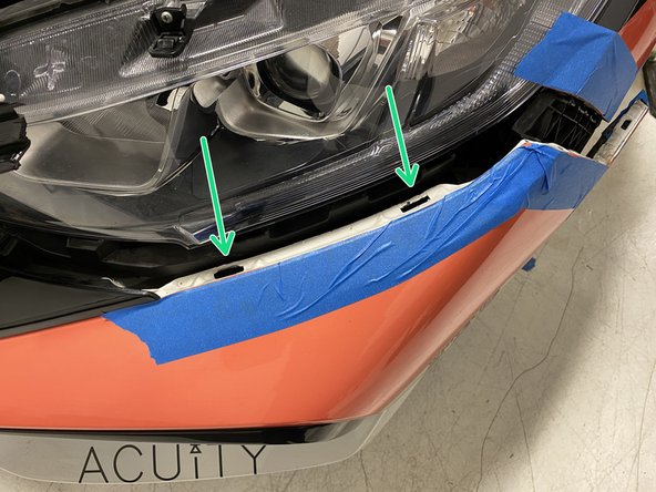 Using a plastic interior trim removal tool, lift up the two tabs to release them