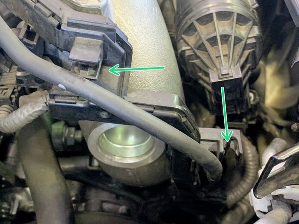 Unclip the vacuum hose from the clips on the vacuum line retainer bracket