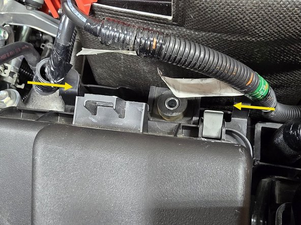 Press the plastic clips on the battery cables into the mounting holes on the airbox as shown