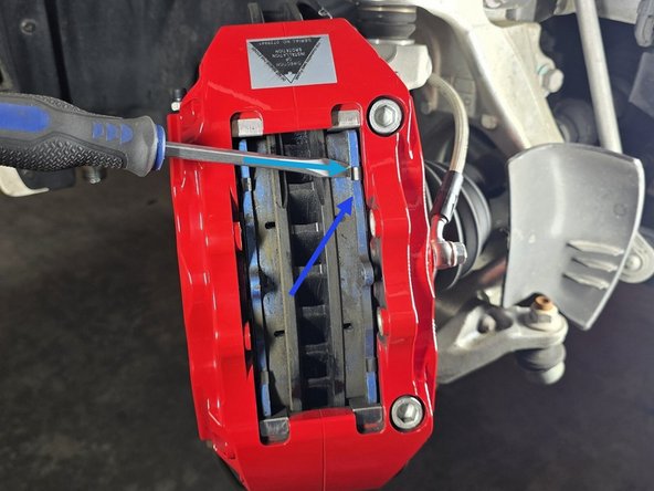 This is easiest if you completely remove one first to ease the tension on the second