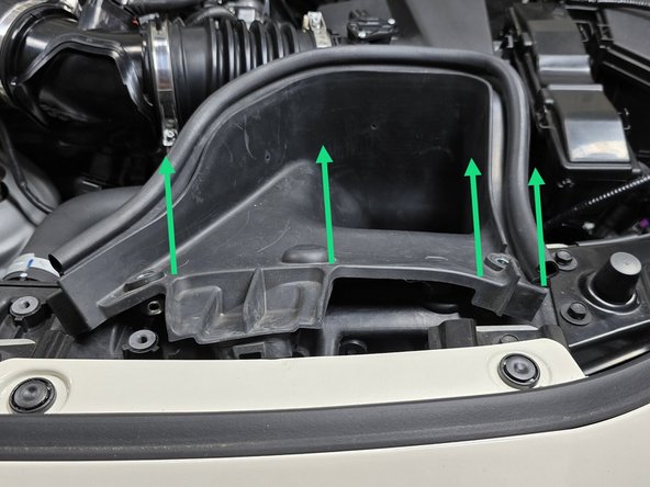 Using your hand pull the rubber end of the duct out of its slot in the radiator shroud