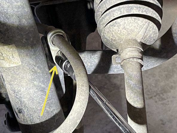 Using 12mm socket on extension, remove the brake line bracket on the strut