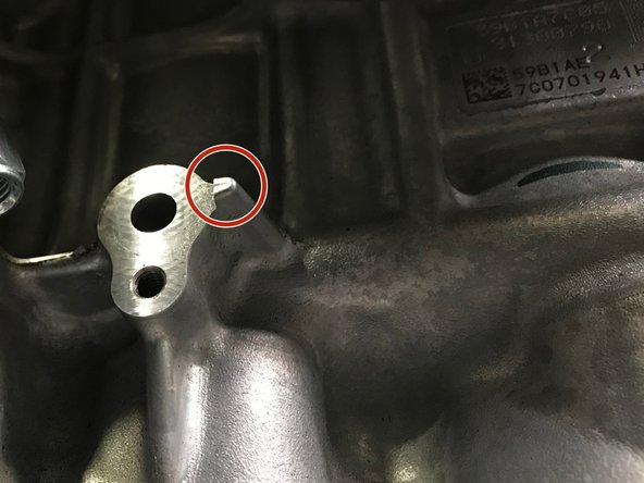 Locate the oil feed block connection location shown in the first image