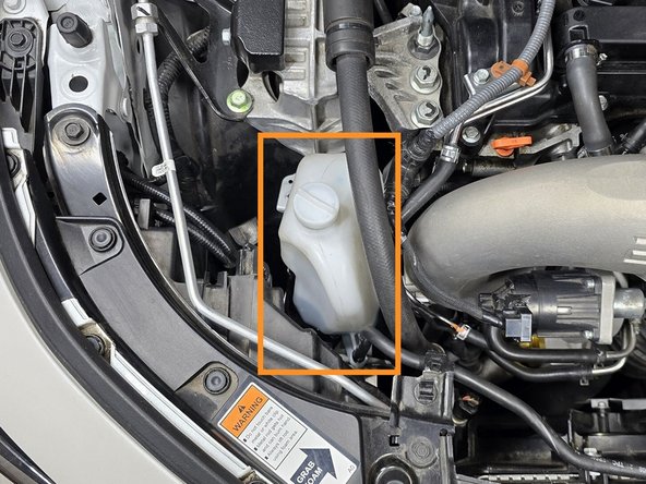 Open the hood to access the OEM coolant reservoir