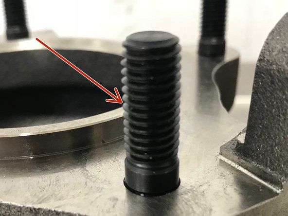 By hand, install the four (4) M10 studs into the turbo with the long section out