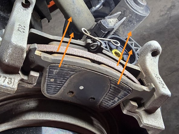 Remove both brake pads as shown, these will come straight up and out