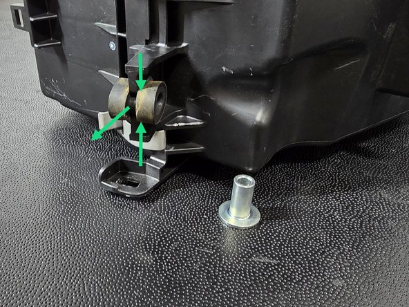 Pinch and remove the rubber spacer as shown