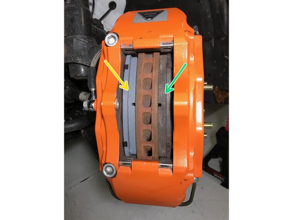 Install the new brake pad into the caliper as shown