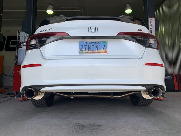 Stand back from the car and verify that the tips are centered and have at least 1/3 inch clearance from the bumper on both sides