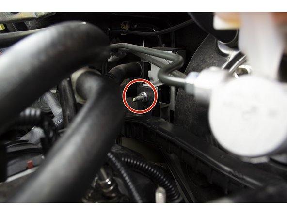 Hook the plastic cable assembly back on the stud and reinstall the 10mm nut with a 10mm deep socket and ratchet