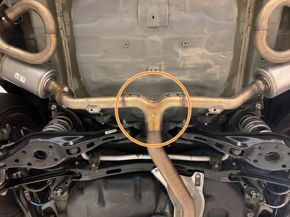 Using a transmission jack, floor jack, or a friend support the OE exhaust in the marked area