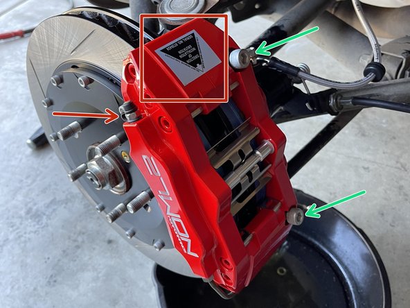 Note the orientation of the left caliper versus the right caliper by the sticker that shows the direction of rotation, and make sure the brake bleeder is pointing up