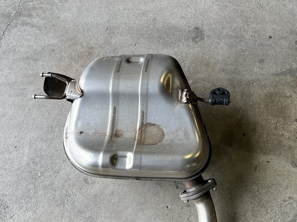 Use tongue and groove pliers or exhaust hanger pliers to remove driver side rubber hanger