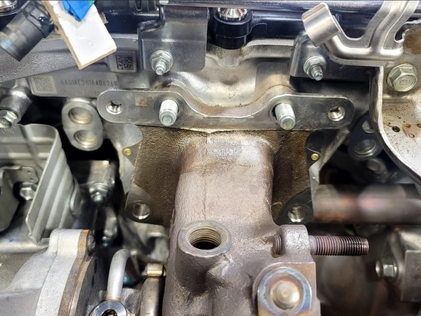 Use 14mm wrench to break loose lower left bolt from turbine housing