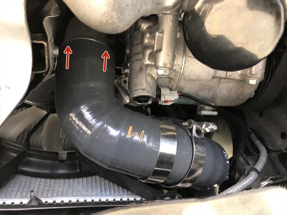 Slide the other end of the 27WON hot side boost tube over the outlet of the turbocharger