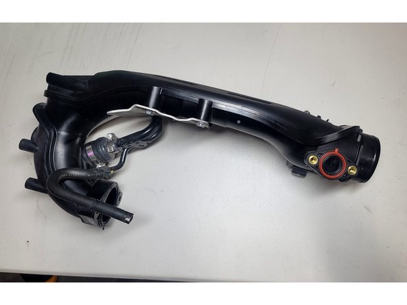 Plug coolant line attached to TIP with finger while removing TIP so as to avoid further coolant spills