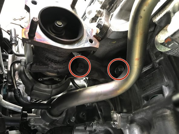Use a 14mm socket &amp; ratchet to remove the two (2) 14mm bolts holding the turbo support bracket