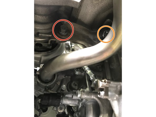 Install the LONG 14mm bolt through the bracket into the turbo