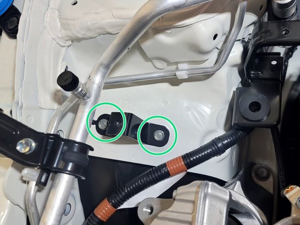 Use a 3/8" ratchet and 10mm socket to remove (2) 10mm bolts securing the upper chassis tank bracket