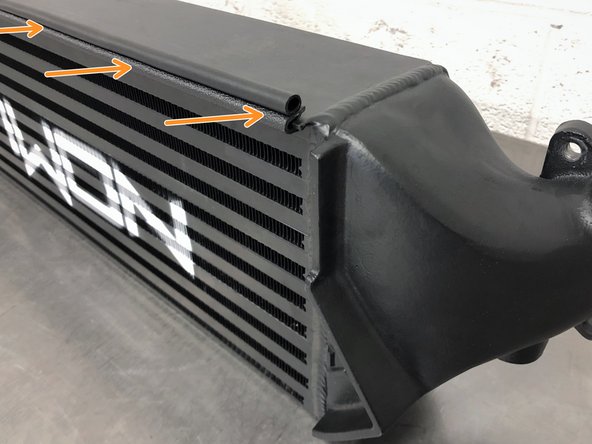 Locate the top edge of the 27WON Intercooler. It sticks out slightly in front of the fins of the intercooler