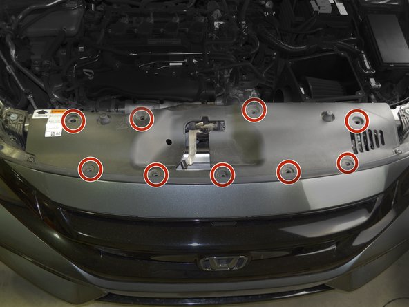 Reinstall radiator fan guard by inserting the 9 plastic clips and pressing down on them with your thumb