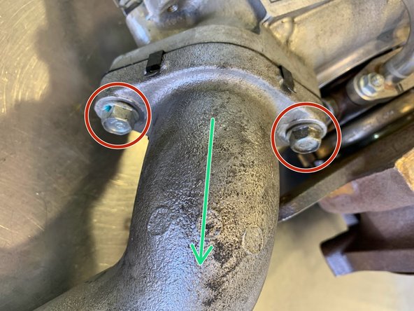 Remove the (2)12mm bolts for the compressor cover outlet pipe