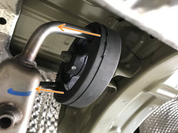 Use the tongue &amp; groove pliers to pull the rubber hanger off the chassis rod in the direction of the red arrows