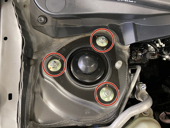 Remove three (3) flange nuts with a 14mm deep socket and ratchet wrench