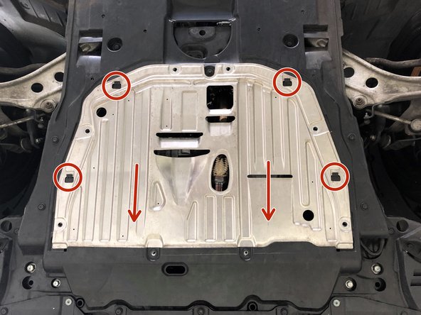 Lift the metal section of the undertray into position