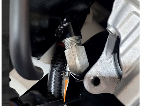 Put the 27WON coolant tank in place and reinstall the coolant hoses over the two barbs and secure with provided clamps or OE clamps where possible