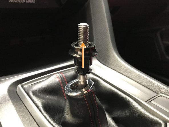 Unthread the OEM locking nut