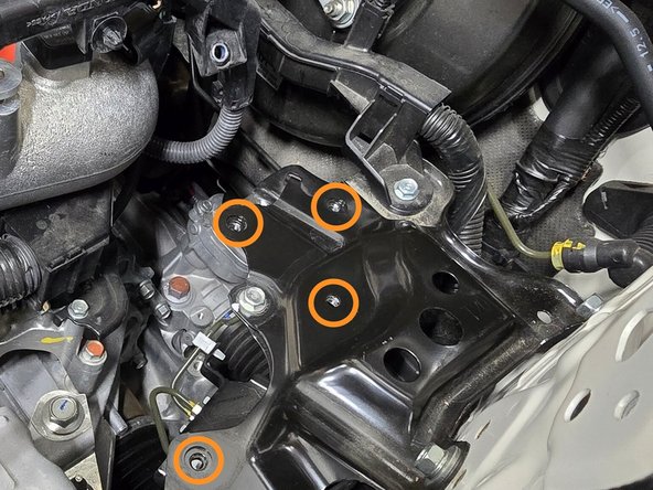 The lower battery bracket will need to align with the four holes circled in orange when reinstalled