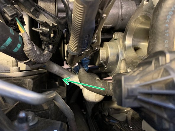 Using needle nose pliers, move the clamp up the silicone hose as shown