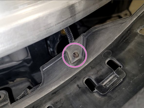 Pull cover slightly off bumper to access loom clip as shown. Remove clip with pliers