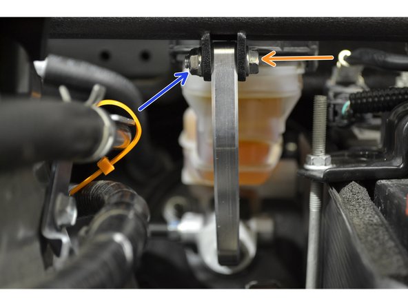 Insert the two M6 x 1mm x 25mm bolts through the holes in the mounting tabs as shown