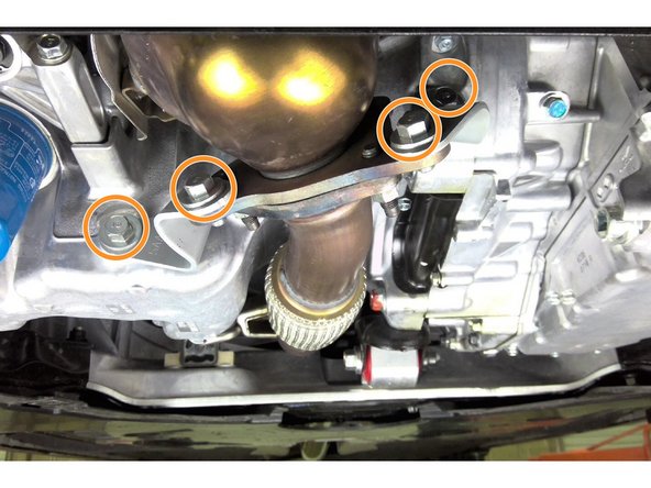 Reinstall the four (4) 14mm bolts securing the two lower downpipe support brackets as shown Torque bolts to 33 ft-lbs