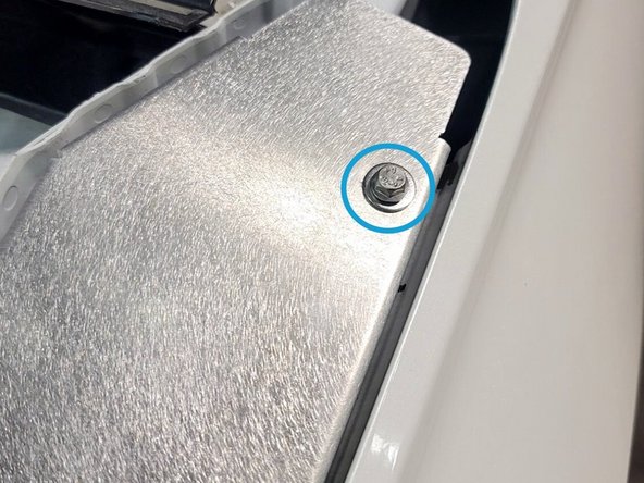 Line up holes on bottom of shroud with the two bolts removed in the last step