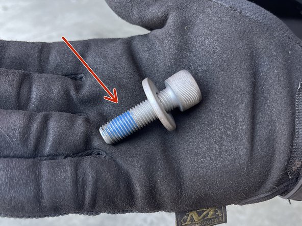 It's recommended applying blue Loctite onto the caliper bracket retaining bolt as shown
